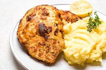 Schnitzel or breaded chop with mashed potatoes