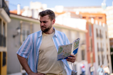 Traveling people, tourist looking at map on the street in France, Europe