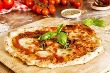 Fresh Homemade Italian Pizza Margherita with dried tomatoes, buffalo mozzarella and basil