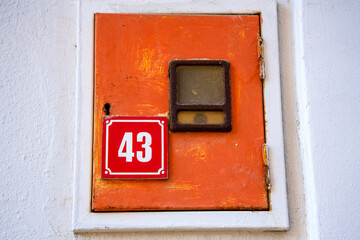 A red house number plate showing the number 43.