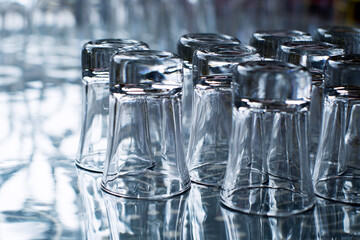 Empty clean glasses for vodka and other drinks in bar closeup, soft focus 