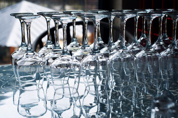 Empty clean glasses for wine and other drinks in bar closeup, soft focus 