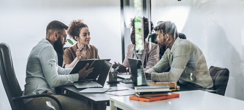 A diverse, casual design team collaborates in the office, creating innovative solutions and fostering in dynamic creative environment.