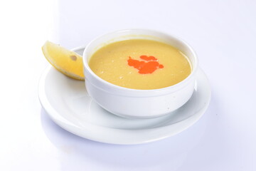 Lentil Soup with lemon and hot oil sauce, in white bowl