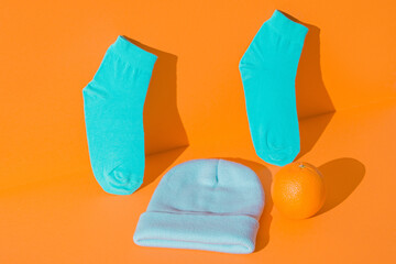 Layout new hat and socks, orange n the background. Mint green orange color