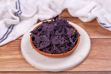 Red basil. Spices concept. Dried red basil spice on wood background. Local name reyhan. Close up