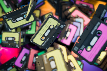 Abstract background consisting of patterns of multi-colored old audio cassettes. 3D render