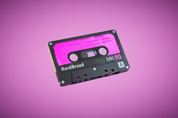 Fototapeta premium An old audio cassette on a pink background. 3D render