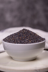 Blue poppy seeds. Spices concept. Blue poppy seeds on dark background. Close up