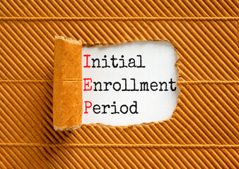 IEP symbol. Concept words IEP Initial enrollment period on beautiful white paper. Beautiful white table brown background. Medical and IEP Initial enrollment period concept. Copy space.