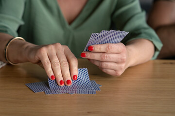 Woman playing with cards close up unrecognizable play