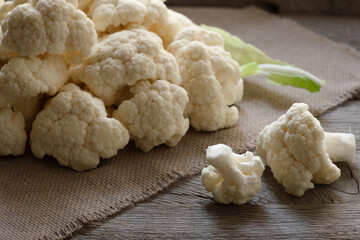 Fresh cauliflower on wooden table, top view