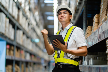 An warehouse manager uses a tablet computer for checking goods in a warehouse. logistics and export business concept large warehouse.