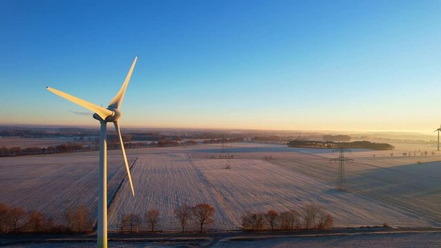 Heerstedt Lohe - Northern Germany - Wind turbines - Flight Aerial view of wind turbines rotating in the icy sunrise