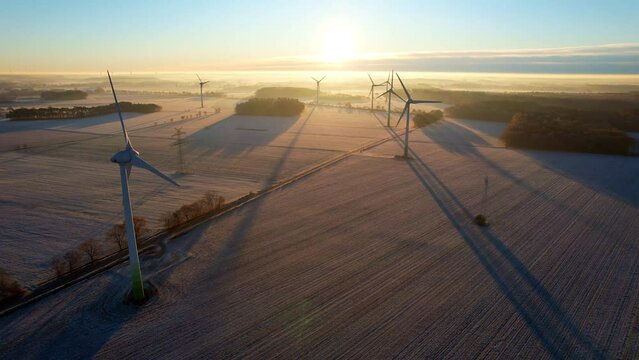 Heerstedt Lohe - Northern Germany - Wind turbines - Flight Aerial view of wind turbines rotating in the icy sunrise