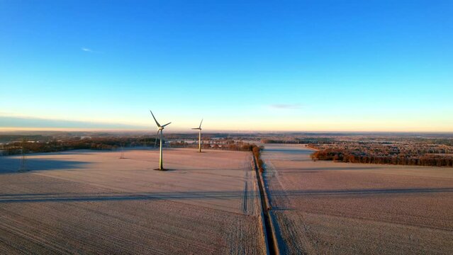 Heerstedt Lohe - Northern Germany - Wind turbines - Flight Aerial view of wind turbines rotating in the icy sunrise