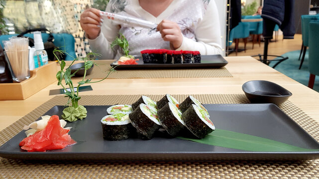 Sushi plat on a table of wood with a plant. High quality photo