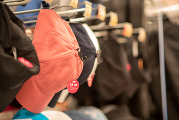 Colorful Baseball Caps with different model peaks hanging on wall. Selective Focus. High quality photo