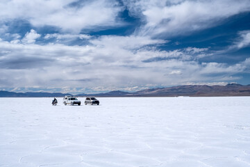 A motorcycle, an old pickup and a car in Las Salinas Grandes in Jujuy Argentina