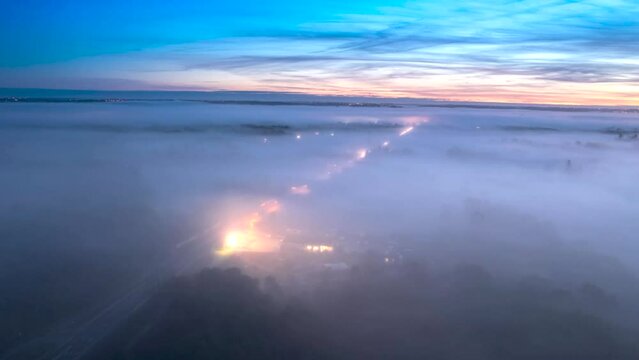Stunning drone timelapse of road traffic above the mist in the morning.