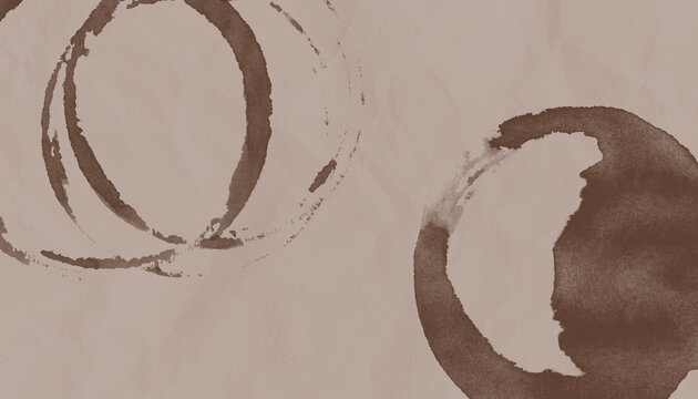 A brown paper with a coffee stain on it