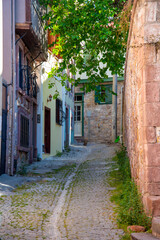 Fototapeta na wymiar Narrow streets in a Turkish city on a summer and sunny day with old and masonry wooden houses.