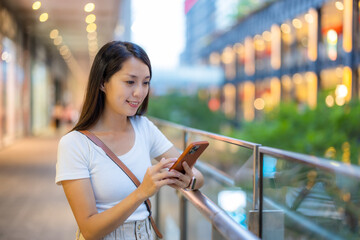 Woman use smart phone in shopping area