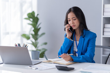 young  asian businesswoman working on laptop computer in her workstation. Portrait of Businesspeople employee freelance online marketing e-commerce telemarketing concept.