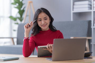 Obraz premium Smile of beautiful woman with earphone and smartphone siting on sofa at home 