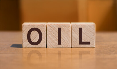 Letter wooden blocks in word OIL on wood background