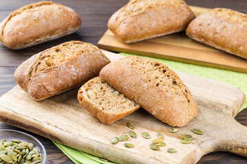 Crispy grain bun on wooden cutting board