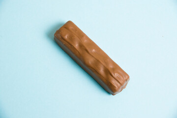 A tasty whole chocolate bar on a blue background