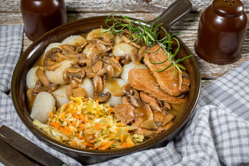 Stewed pork chop in a bright mushroom sauce.