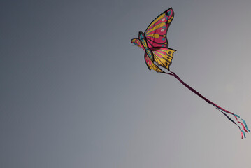 colorful kite flying in blue sky. High quality photo