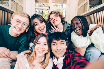 multi ethnic group of young people taking selfie