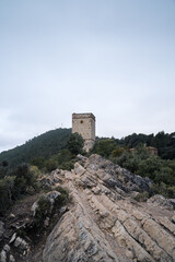 Fototapeta na wymiar Rocky Path Leading to Telegraph Tower on the Hill with Overcast Sky