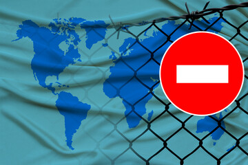 world map on satin, fence with barbed wire, symbolic red sign no entry, entry is prohibited, travel...