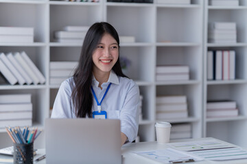 Smiling of business women holding coffee cup working in the office.