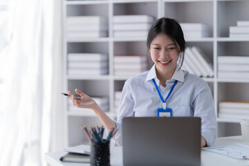 Smiling of business women holding coffee cup working in the office.