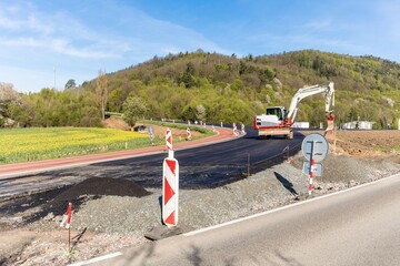 Bagr on the construction of a new road in the Czech Republic. Construction work. Reconstruction of the road.