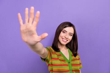 Photo of sweet shiny lady wear striped cardigan waving arm hi isolated purple color background