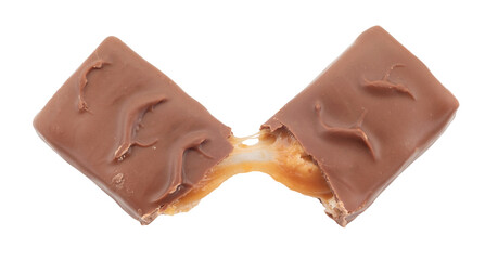 The chocolate bar is broken into two halves. Bar with nuts, nougat and caramel