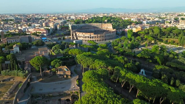 Top view of the Colosseum and Palatine Hill, Historical landmarks in Rome, Italy. Aerial view of the sunrise over the old ancient Italian top destination and country symbol Colosseum in ProRes 4K.