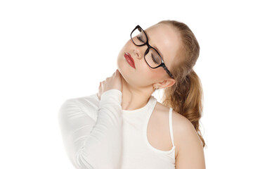 beautiful young woman with glasses has a pain in the neck isolated on white background