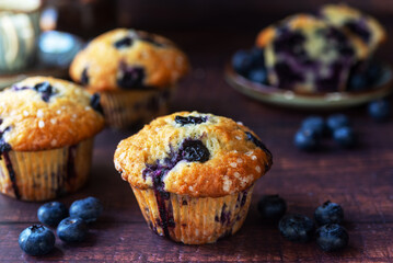 freshly baked homemade blueberry muffins on wooden table background.