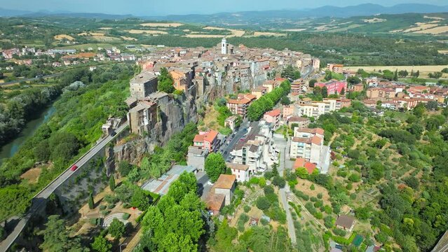 Top view of a small town in Italy with Old Colorful Italian buildings and houses. Aerial panoramic view of Orte a former Catholic bishopric and Latin titular Town in Europe on a rocky stone hill.