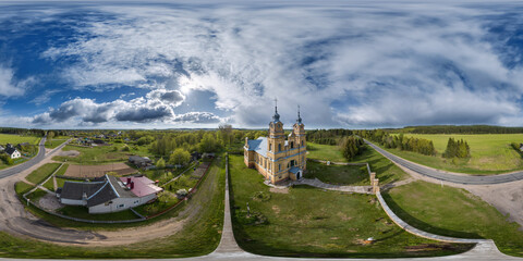 aerial full hdri 360 panorama view of yellow red bricks baroque catholic church in countryside in...
