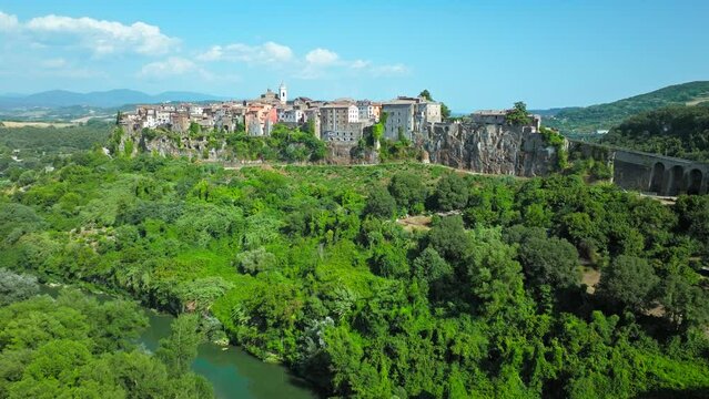 Top view of a small town in Italy with Old Colorful Italian buildings and houses. Aerial panoramic view of Orte a former Catholic bishopric and Latin titular Town in Europe on a rocky stone hill.