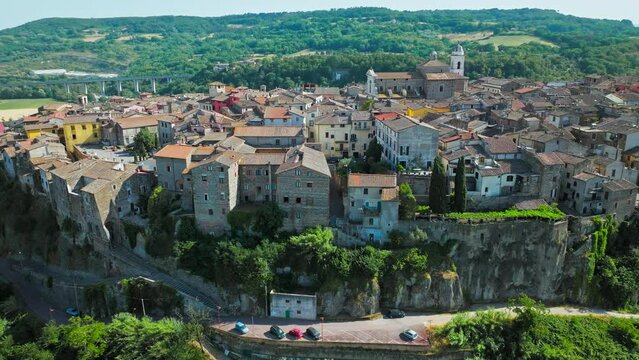 Top view of a small town in Italy with Old Colorful Italian buildings and houses. Aerial panoramic view of Orte a former Catholic bishopric and Latin titular Town in Europe on a rocky stone hill.