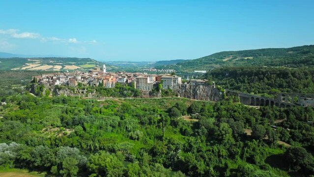 Top view of a small town in Italy with Old Colorful Italian buildings and houses. Aerial panoramic view of Orte a former Catholic bishopric and Latin titular Town in Europe on a rocky stone hill.